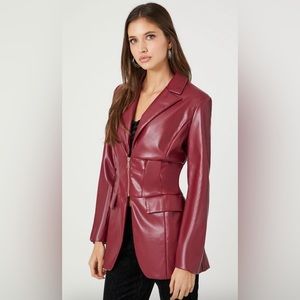 Faux leather blazer with zip-up closure, pockets, long sleeves.